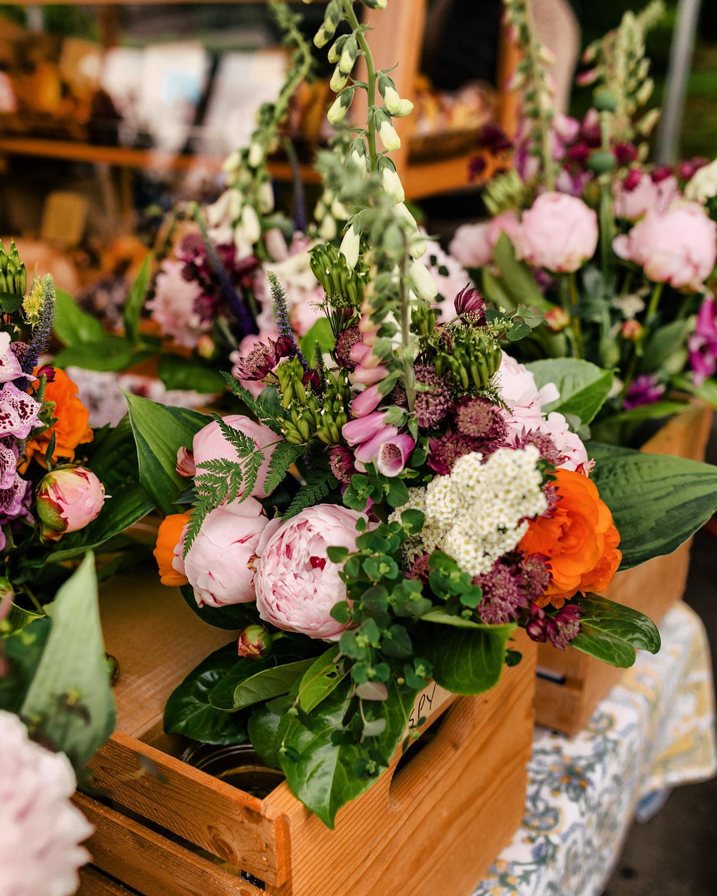 Flower display bouquets in wooden crates at the Qualicum Beach Farmers Market.