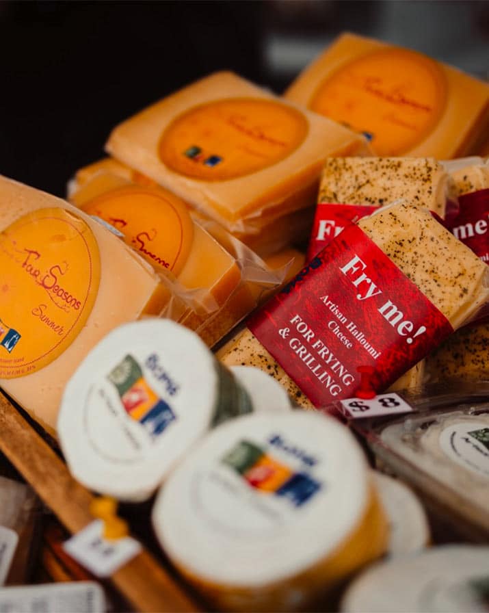 A close up shot of local cheese at a farmers market.